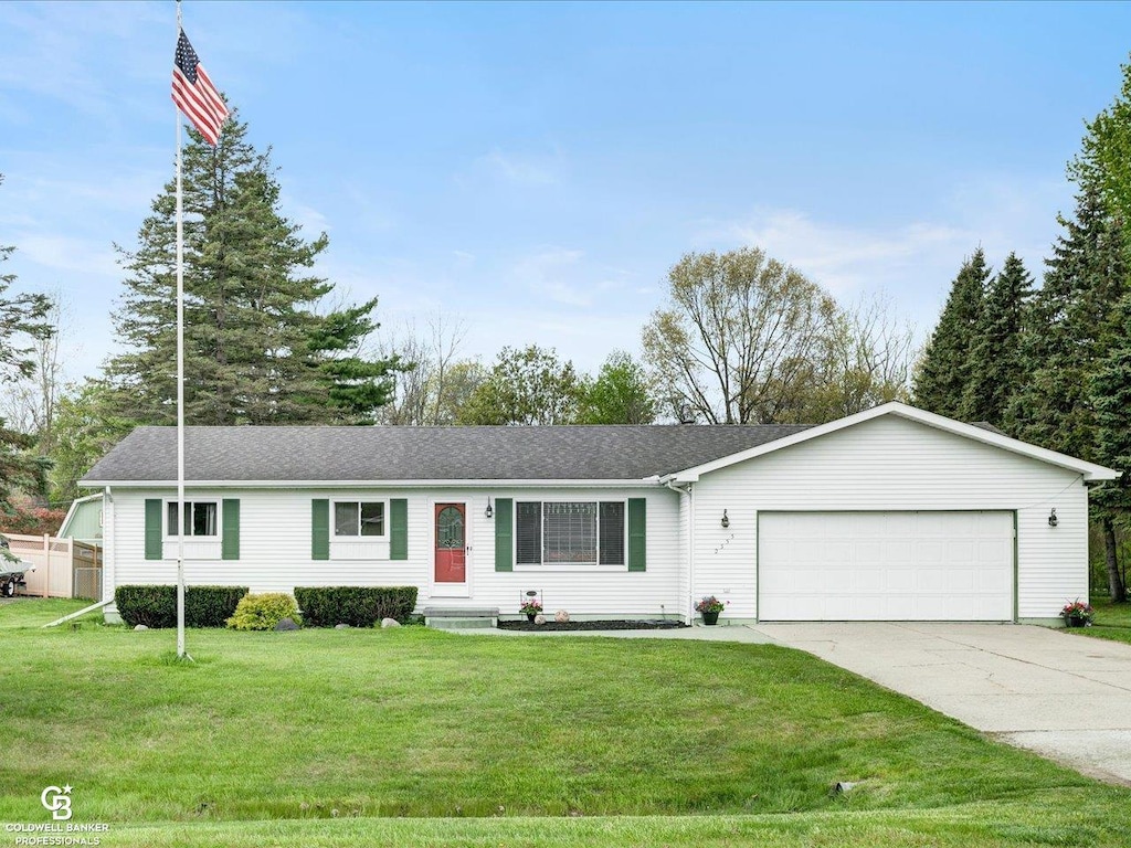 2355 Randolph St, Port Huron, MI 48060 - ranch-style home with a garage, driveway, a front yard, and roof with shingles