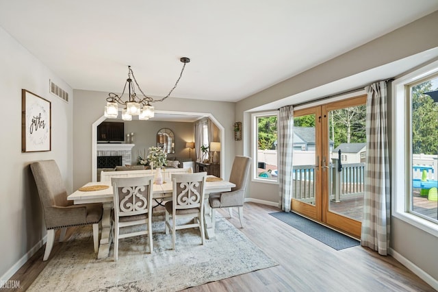 35657 Pierce St, Richmond, MI 48062 - dining space with wood finished floors, baseboards, french doors, and a fireplace