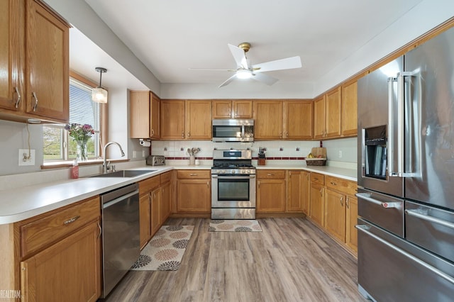 35657 Pierce St, Richmond, MI 48062 - kitchen with appliances with stainless steel finishes, light wood finished floors, ceiling fan, light countertops, and a sink