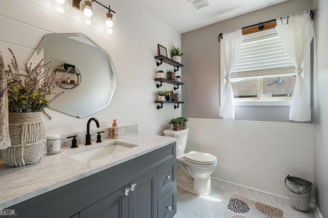 35657 Pierce St, Richmond, MI 48062 - bathroom with toilet, vanity, marble look tiles, and wood walls