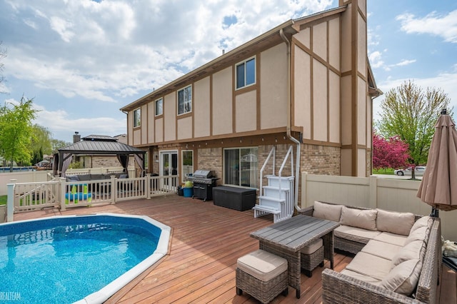 35657 Pierce St, Richmond, MI 48062 - back of house with an outdoor living space, a wooden deck, a gazebo, fence, and brick siding