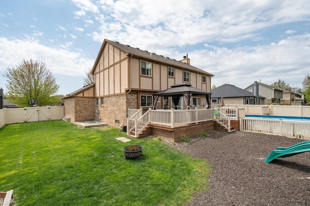 35657 Pierce St, Richmond, MI 48062 - back of property with a gazebo, a gate, a fire pit, brick siding, and a chimney