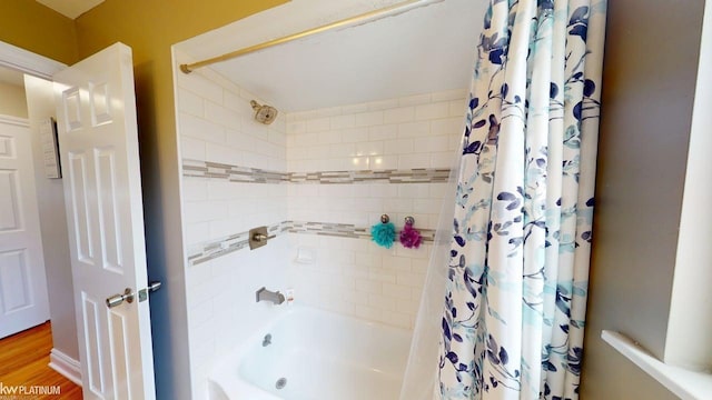 bathroom featuring shower / bath combo with shower curtain and wood finished floors