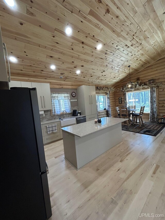 1322 W Northwoods Ln, Hardwood, MI 49834 - kitchen with freestanding refrigerator, a sink, wooden ceiling, a center island, and white cabinets