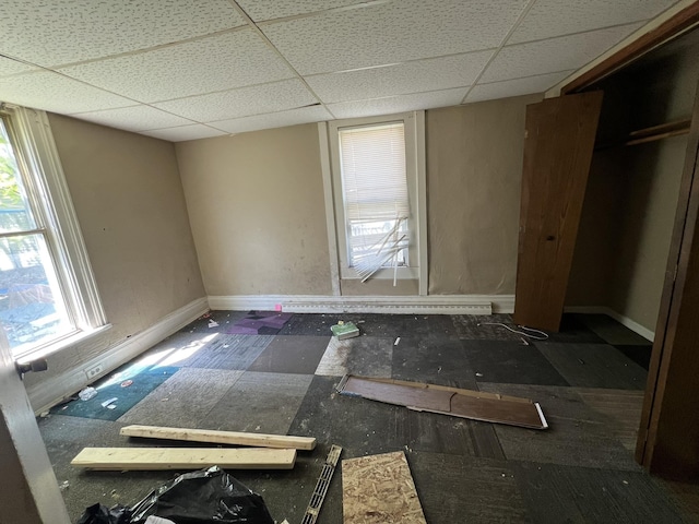 106 S Chilson St, Bay City, MI 48706 - unfurnished bedroom featuring a drop ceiling and baseboards