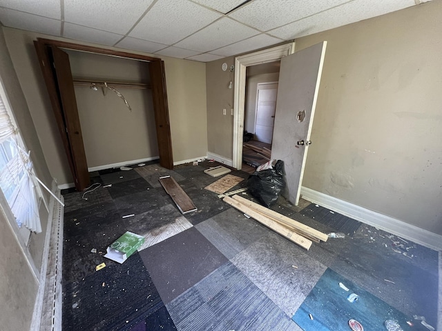 106 S Chilson St, Bay City, MI 48706 - unfurnished bedroom with baseboards, a closet, and a drop ceiling