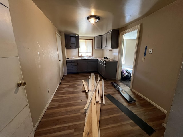 106 S Chilson St, Bay City, MI 48706 - kitchen with gray cabinetry, dark wood-type flooring, and baseboards