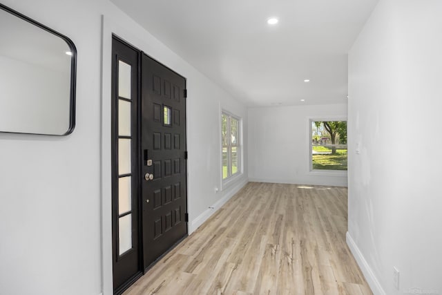 entrance foyer featuring light wood-style flooring, baseboards, and recessed lighting
