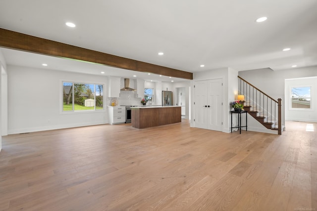 7533 Roberta Ln, Washington T-Wi, MI 48094 - unfurnished living room featuring recessed lighting, stairs, light wood finished floors, beam ceiling, and baseboards