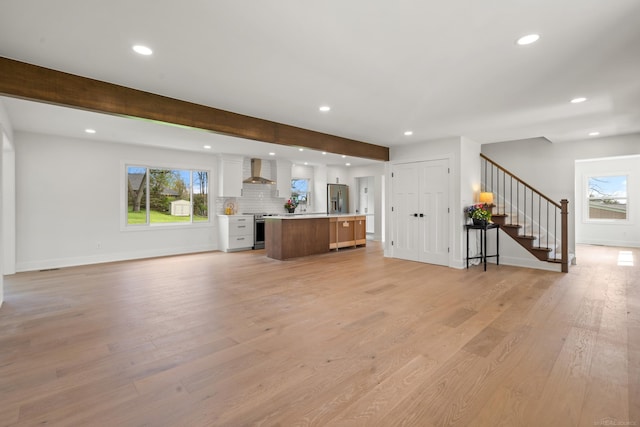 7533 Roberta Ln, Washington T-Wi, MI 48094 - unfurnished living room featuring recessed lighting, stairs, light wood-style floors, baseboards, and beamed ceiling