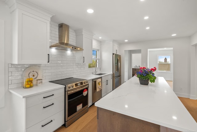 7533 Roberta Ln, Washington T-Wi, MI 48094 - kitchen featuring appliances with stainless steel finishes, wall chimney range hood, a sink, a kitchen island, and backsplash