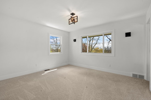 7533 Roberta Ln, Washington T-Wi, MI 48094 - carpeted spare room featuring baseboards and a chandelier