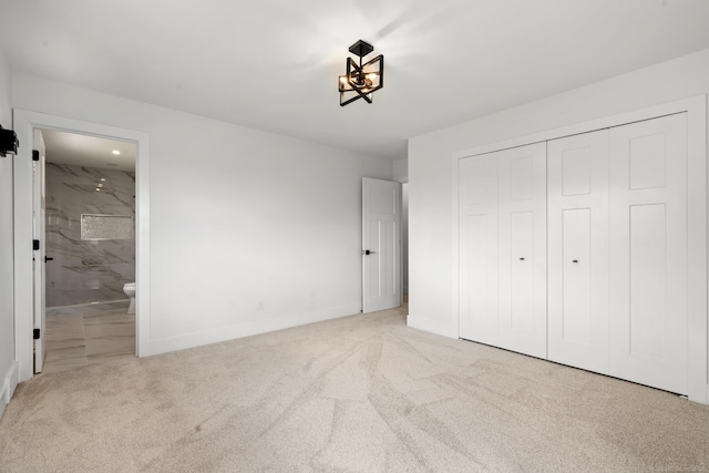 7533 Roberta Ln, Washington T-Wi, MI 48094 - unfurnished bedroom featuring carpet floors, a closet, baseboards, connected bathroom, and a chandelier