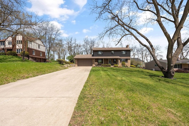 7533 Roberta Ln, Washington T-Wi, MI 48094 - view of front of home featuring a chimney, a front lawn, driveway, and a garage