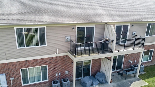 14225 Shadywood Dr, Sterling Heights, MI 48312 - rear view of house with a patio area, central air condition unit, brick siding, and a balcony