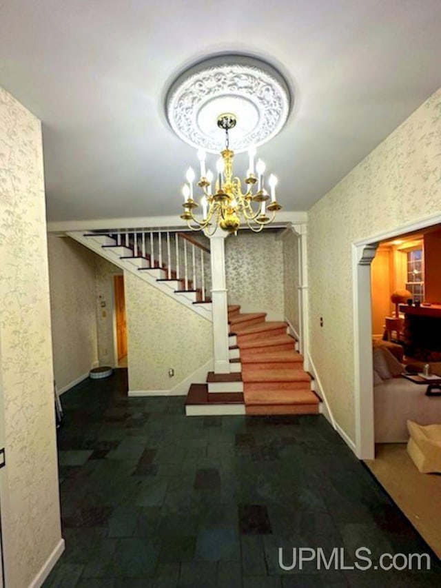 258 W Jasper St, Gwinn, MI 49841 - staircase with baseboards, a chandelier, and wallpapered walls