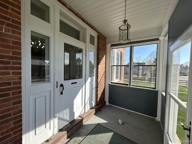 258 W Jasper St, Gwinn, MI 49841 - unfurnished sunroom with healthy amount of natural light and a chandelier