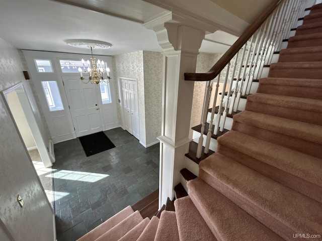 258 W Jasper St, Gwinn, MI 49841 - foyer featuring wallpapered walls, stone finish floors, stairway, a chandelier, and baseboards