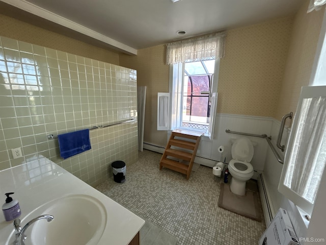 258 W Jasper St, Gwinn, MI 49841 - full bathroom with wallpapered walls, toilet, baseboard heating, double vanity, and a wainscoted wall