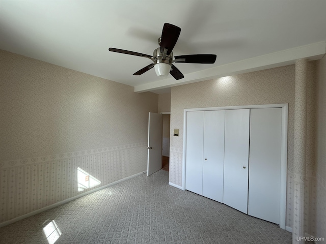 258 W Jasper St, Gwinn, MI 49841 - unfurnished bedroom featuring wallpapered walls, a closet, baseboards, carpet, and a ceiling fan