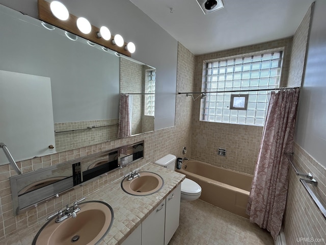 258 W Jasper St, Gwinn, MI 49841 - full bath with tile walls, toilet, shower / bath combo, double vanity, and tile patterned flooring