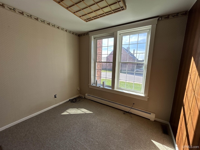 258 W Jasper St, Gwinn, MI 49841 - empty room featuring a baseboard heating unit, plenty of natural light, and carpet