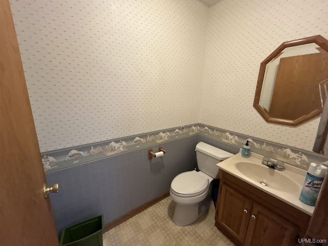 258 W Jasper St, Gwinn, MI 49841 - half bathroom featuring wallpapered walls, wainscoting, toilet, and vanity
