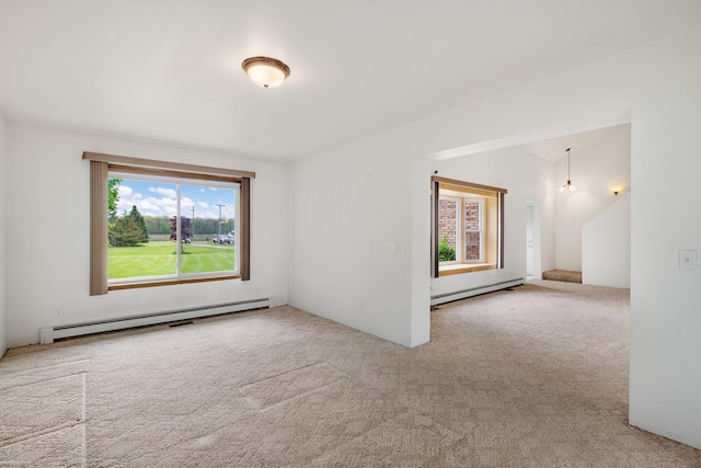 spare room featuring a baseboard radiator and carpet