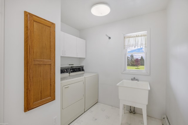 laundry area featuring cabinet space, separate washer and dryer, and baseboard heating