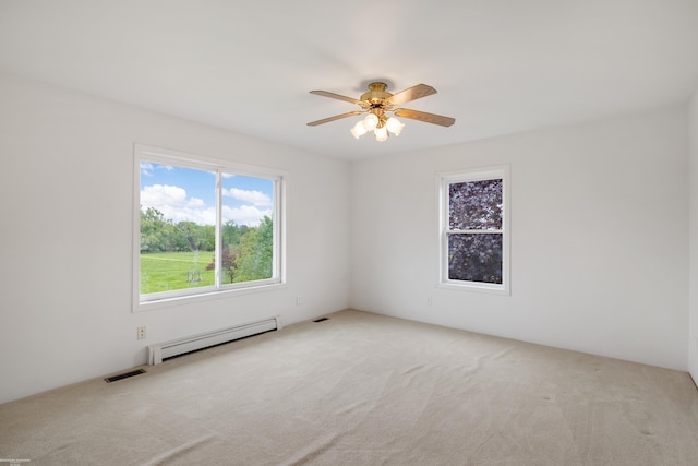 carpeted spare room featuring a baseboard radiator and a ceiling fan