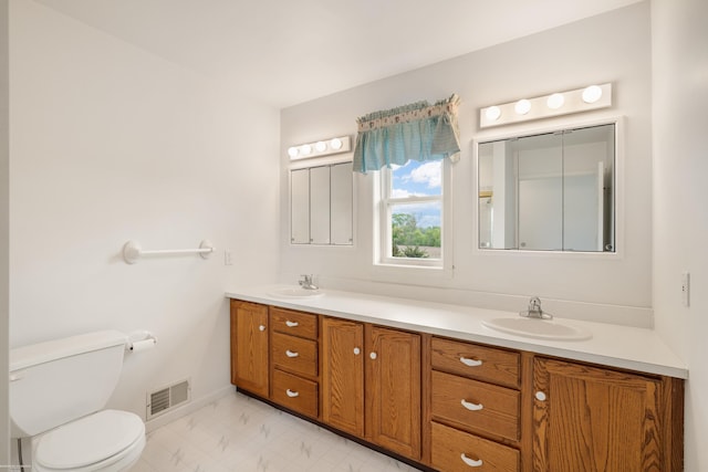 full bath with toilet, double vanity, marble look tiles, and baseboards