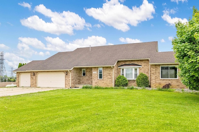view of front of house with a front lawn, a garage, and brick siding