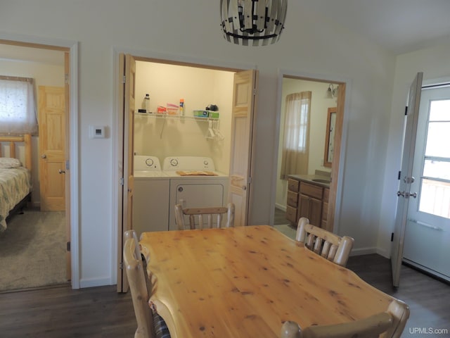 8653 Ll Rd, Rapid River, MI 49878 - dining space with independent washer and dryer, dark wood-type flooring, baseboards, and a chandelier