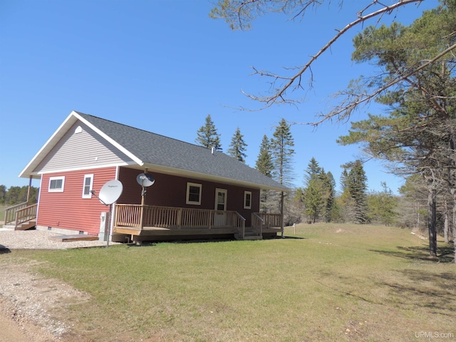 8653 Ll Rd, Rapid River, MI 49878 - view of property exterior featuring a yard, a deck, and a shingled roof