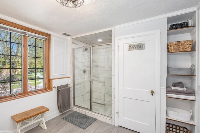 2758 Military St, Port Huron, MI 48060 - bathroom with a shower stall, plenty of natural light, a textured ceiling, baseboards, and wood finished floors