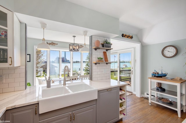 2758 Military St, Port Huron, MI 48060 - kitchen with open shelves, gray cabinets, a sink, and healthy amount of natural light