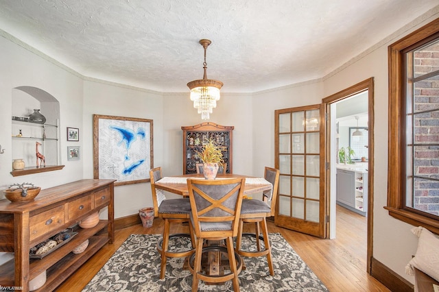 2758 Military St, Port Huron, MI 48060 - dining space featuring light wood-style floors, a textured ceiling, plenty of natural light, and baseboards
