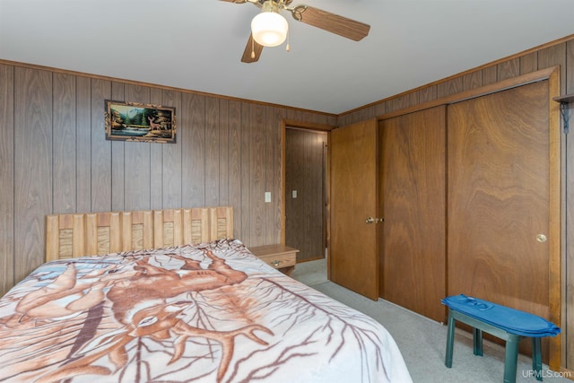 723 Old Beechwood Rd, Iron River, MI 49935 - bedroom featuring wood walls, carpet, ceiling fan, and a closet