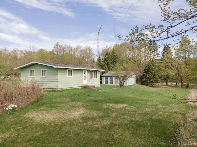 723 Old Beechwood Rd, Iron River, MI 49935 - back of property featuring an outbuilding, a lawn, and entry steps