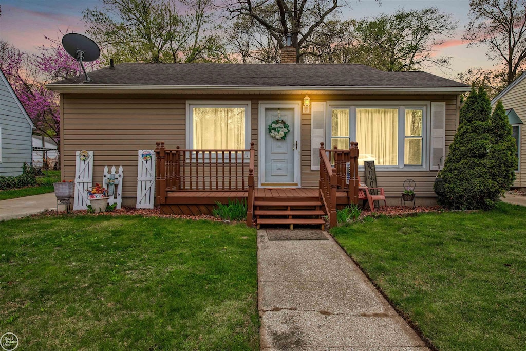3313 Pine Grove Ave, Port Huron, MI 48060 - bungalow featuring a front yard, a chimney, and covered porch