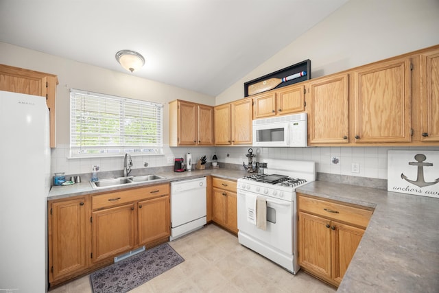 kitchen with white appliances, a sink, vaulted ceiling, tasteful backsplash, and light countertops