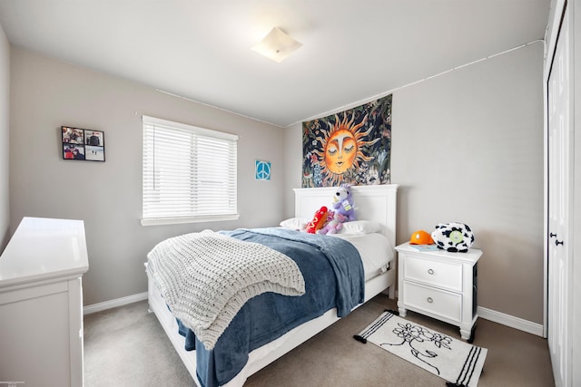 bedroom featuring carpet and baseboards