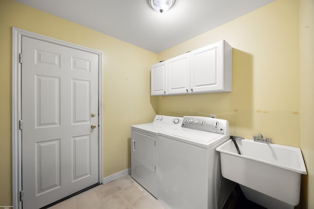 laundry area with washer and clothes dryer, cabinet space, and baseboards