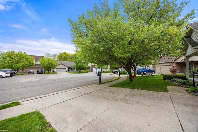 view of asphalt street with sidewalks and a residential view
