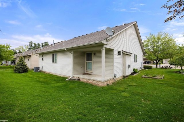 view of side of property with cooling unit, a yard, and roof with shingles