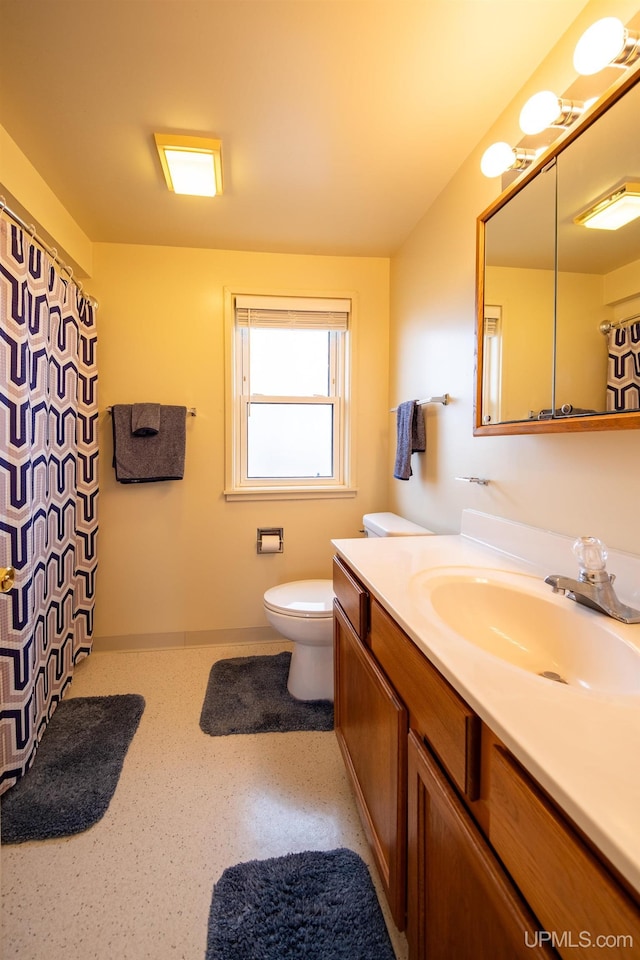405 Mustang St, Gwinn, MI 49841 - full bathroom with vanity, baseboards, toilet, and a shower with curtain