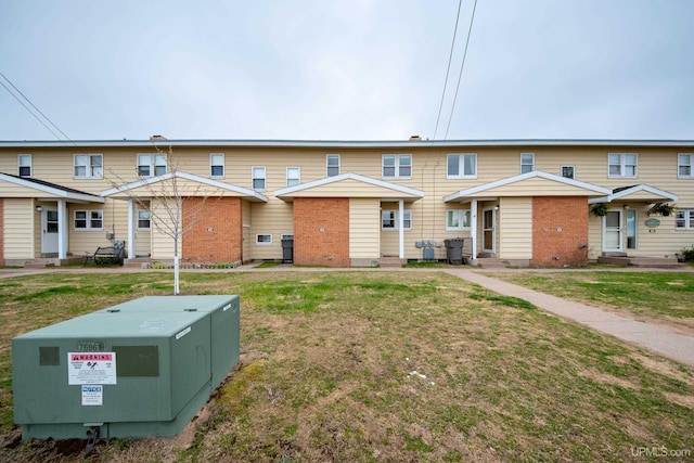 405 Mustang St, Gwinn, MI 49841 - back of property featuring entry steps, brick siding, and a lawn