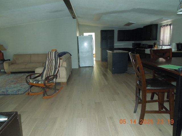 1582 Oakwood St, Gladwin, MI 48624 - living area with lofted ceiling and light wood-style flooring