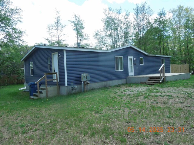 1582 Oakwood St, Gladwin, MI 48624 - back of property featuring a wooden deck and a yard