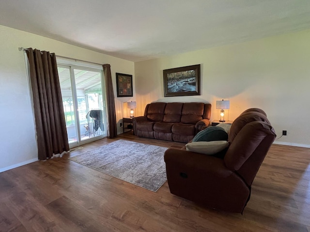 living area featuring wood finished floors and baseboards